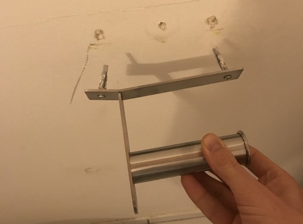 The IKEA toilet paper holder got bent by the back of my head and torn out of the wall